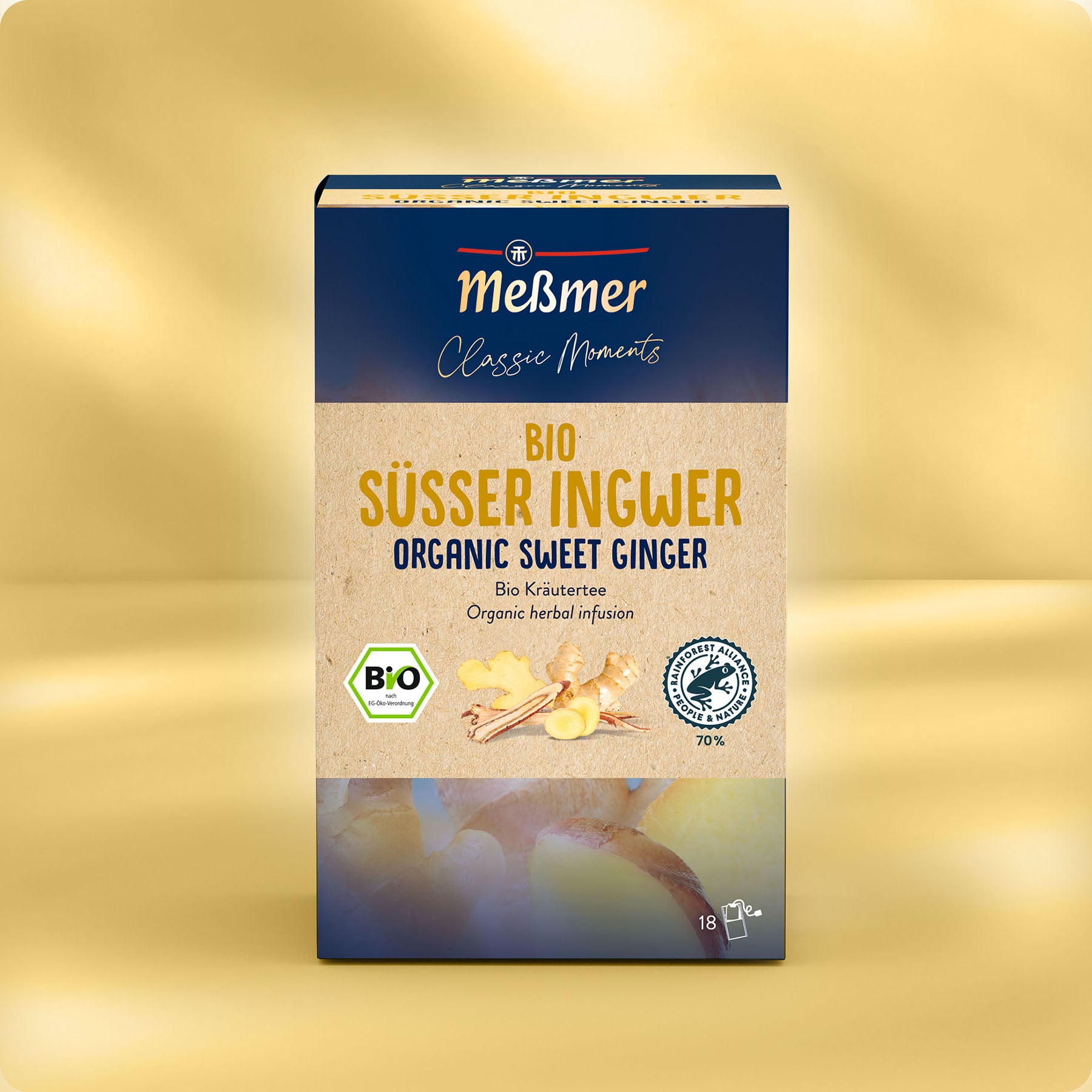 Eine Schachtel Meßmer DE Bio Süßer Ingwer Tee mit Bildern von Ingwer und Zitronengras, Zertifizierungslogos und deutsch/englischem Text auf gelbem und blauem Hintergrund.