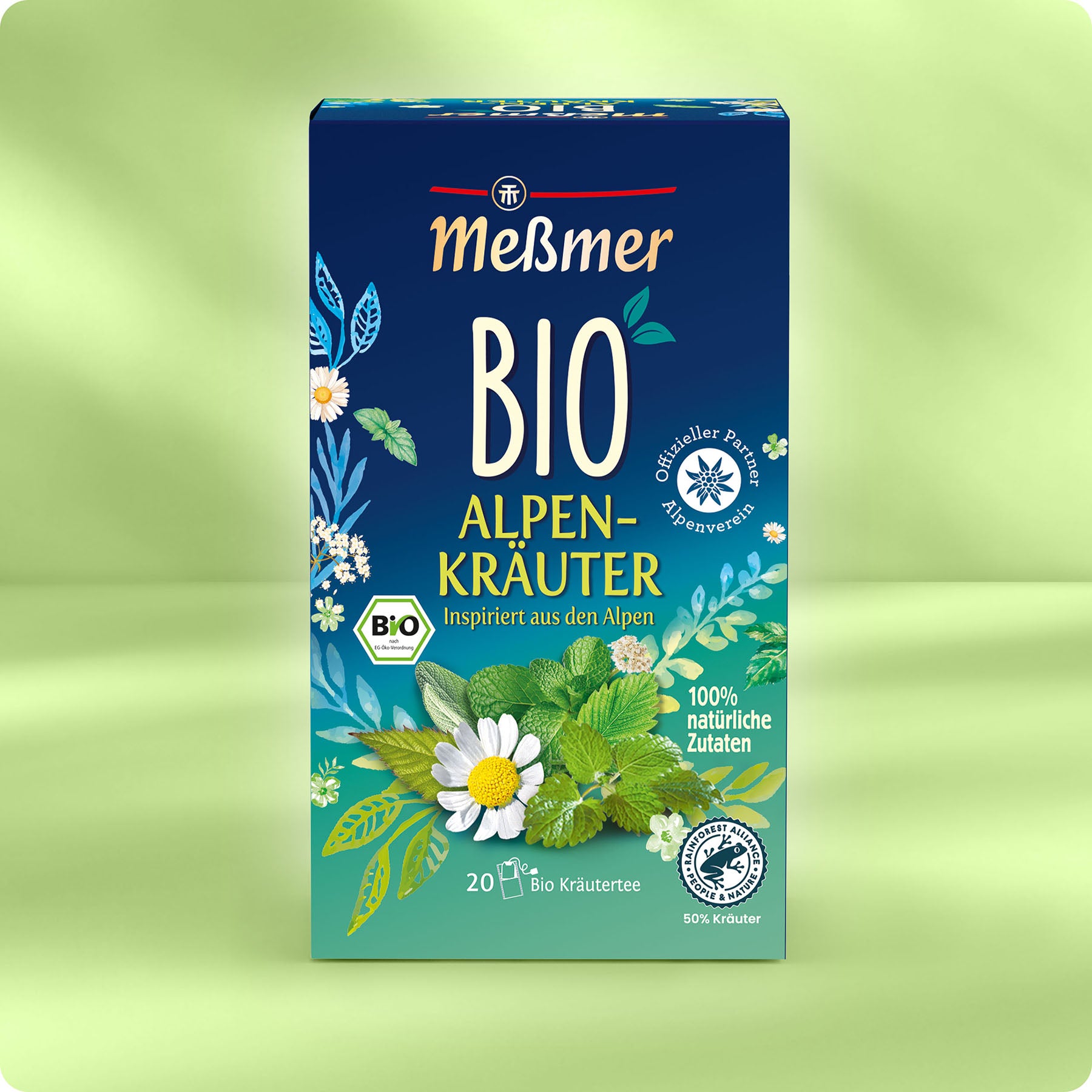 Schachtel Meßmer DE Bio Alpenkräuter Tee, mit Blumen- und Kräutermotiven auf grünem und blauem Hintergrund. Hebt die Bio Tee Zutaten und die alpine Inspiration hervor. Enthält 20 Teebeutel.