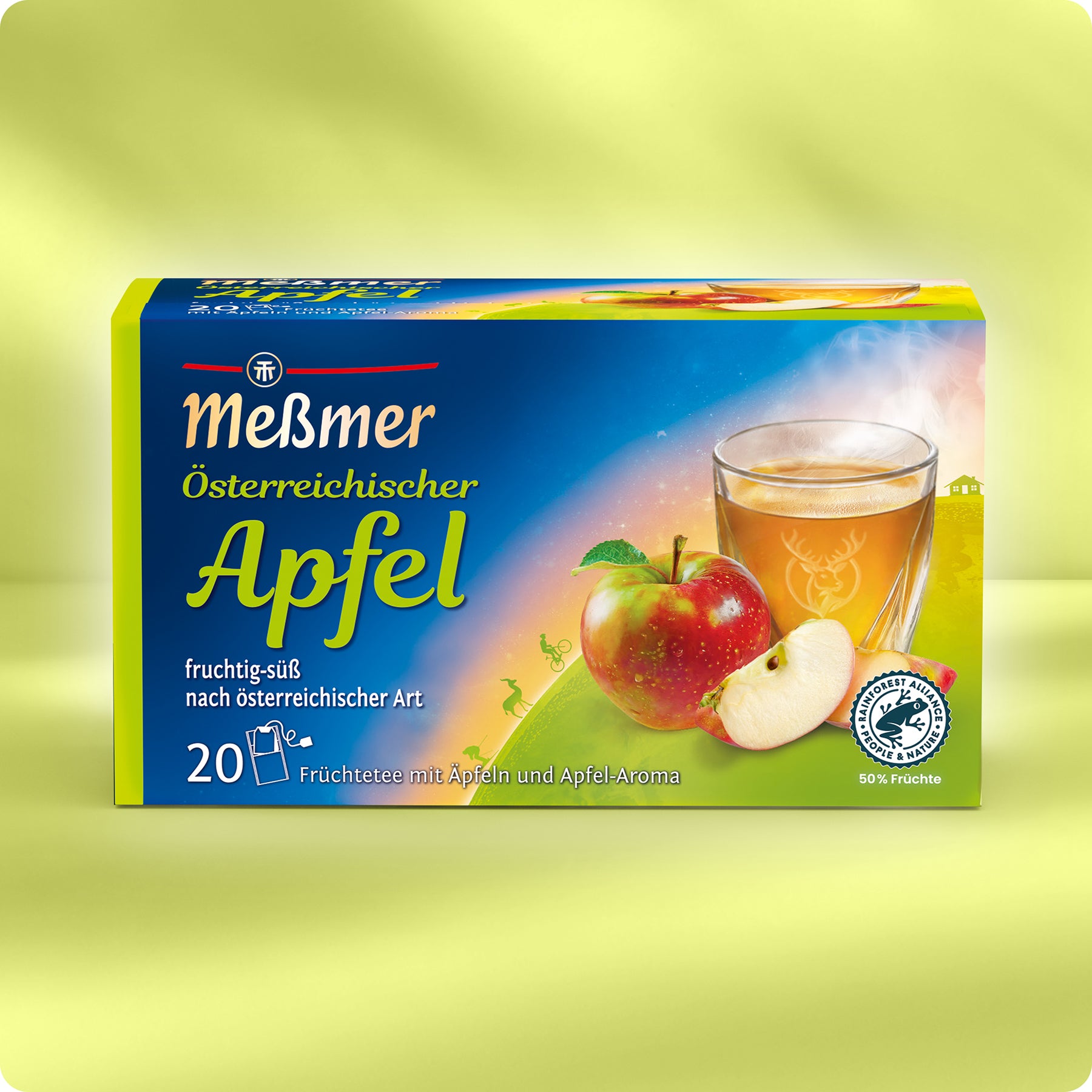 Eine Schachtel Meßmer DE Österreichischer Apfel Tee aus der Alpenregion mit einer farbenfrohen Verpackung mit einem Glas fruchtig-süßem Apfeltee, einem ganzen Apfel und einem aufgeschnittenen Apfel. Enthält 20 Teebeutel.
